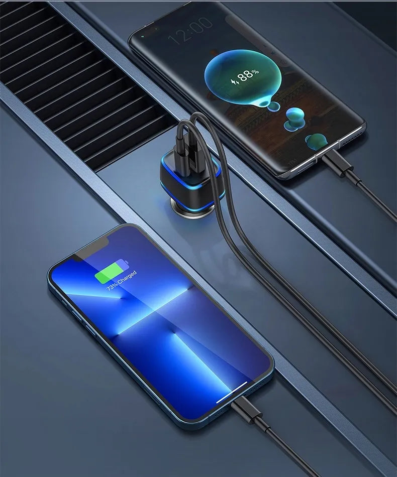 Two smartphones charging with a car charger on a dark surface