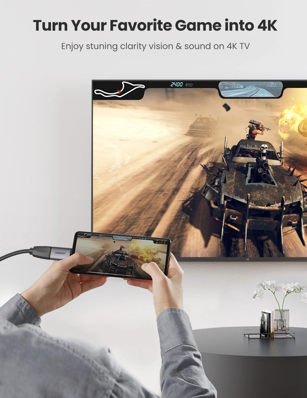 Person using a smartphone to display a game on a large screen with text 'Turn Your Favorite Game into 4K'.