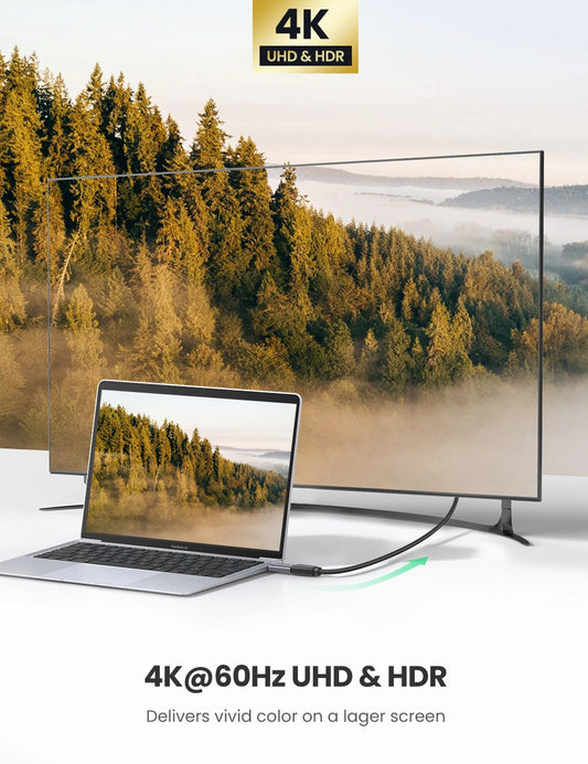 Laptop displaying a nature scene with a large screen behind it, emphasizing 4K UHD & HDR technology.