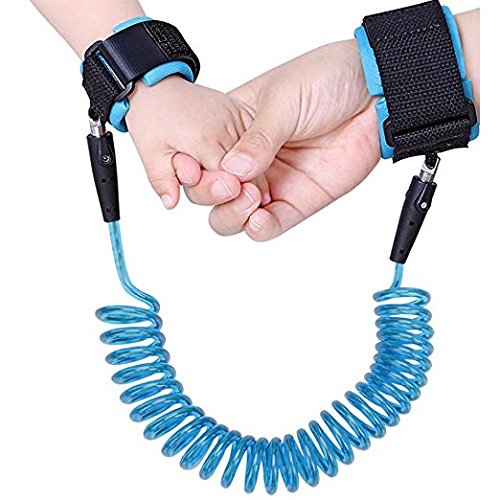 Two hands holding a blue children's leash with black straps on a white background
