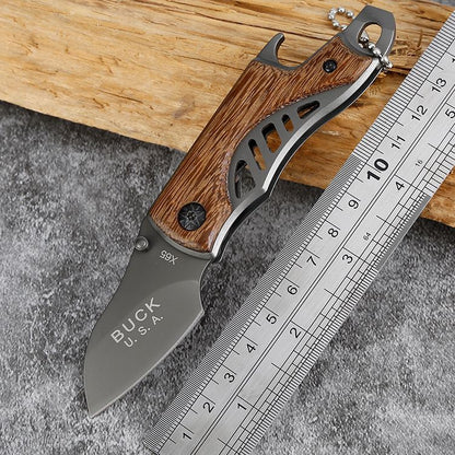 Folding knife with wooden handle next to a ruler on a concrete surface