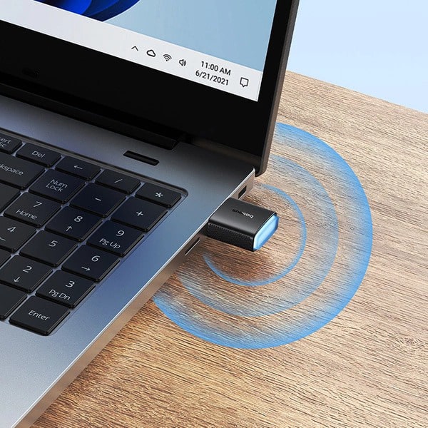 USB adapter connected to a laptop on a wooden surface