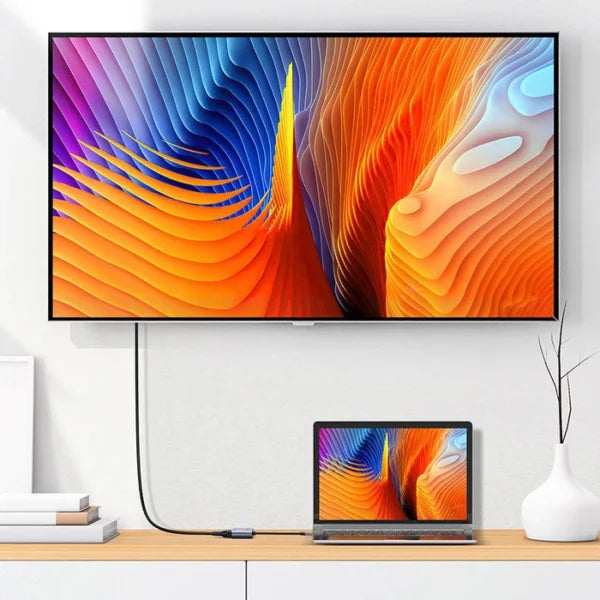 Colorful abstract design on a TV screen with a laptop displaying the same design.