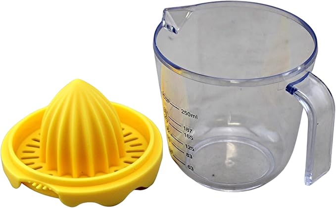 Yellow manual juicer and clear measuring cup on a white background