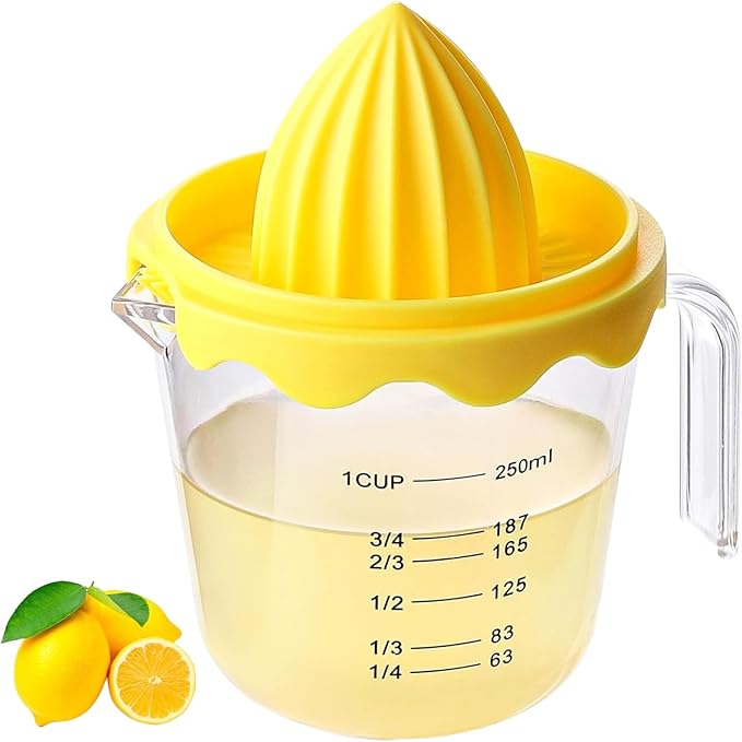 Yellow manual juicer with a clear measuring cup filled with lemon juice, accompanied by lemons on a white background.