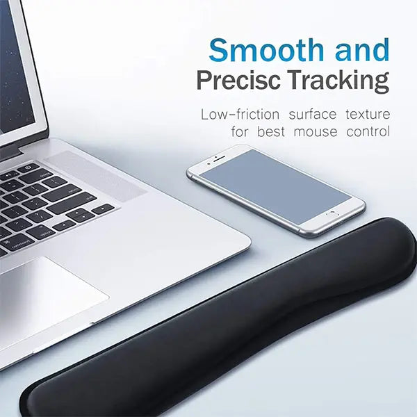 Black wrist pad on a desk with laptop and phone, text about smooth and precise tracking.