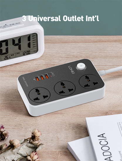 Power strip with multiple outlets on a wooden surface next to a digital clock and book.