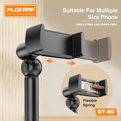 Phone holder with flexible spring mechanism on a beige background, featuring Plokama branding.