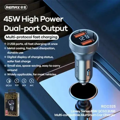 Remax car charger with dual-port output and digital display on a reflective surface.