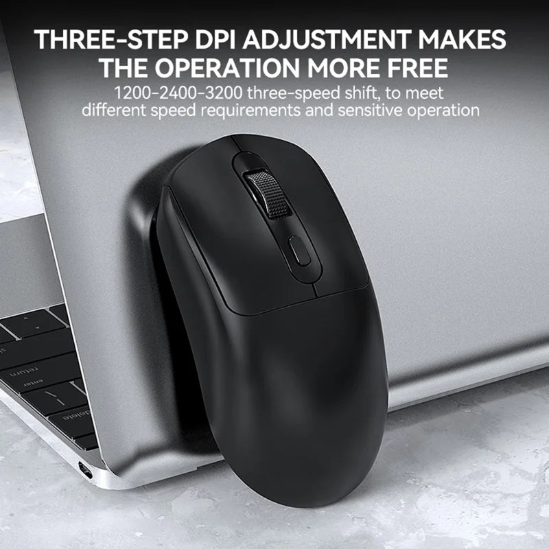 Black computer mouse on a laptop with text about DPI adjustment