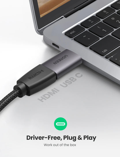 HUB USB-C cable connected to a laptop with 'ugreen' branding on a light gray background.