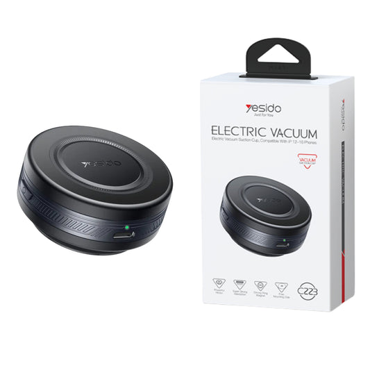 Black electric vacuum cleaner next to its packaging on a white background