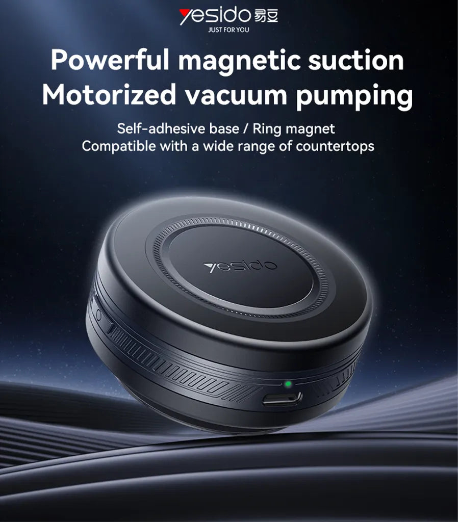 Motorized vacuum pump with powerful suction, self-adhesive base, and ring magnet on a dark background.