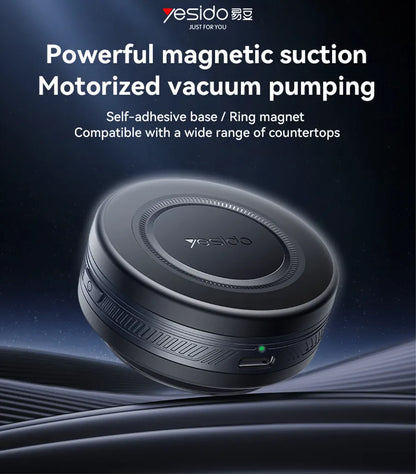 Motorized vacuum pump with powerful suction, self-adhesive base, and ring magnet on a dark background.