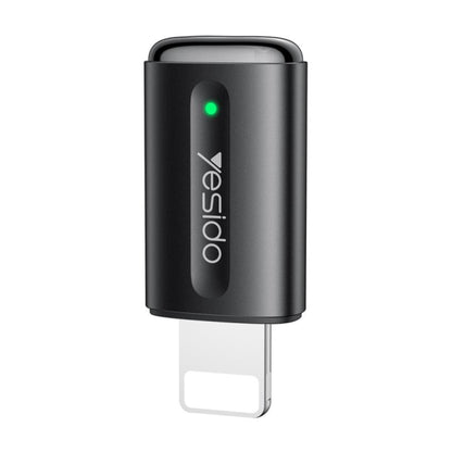 Black car air freshener with a green light on a white background